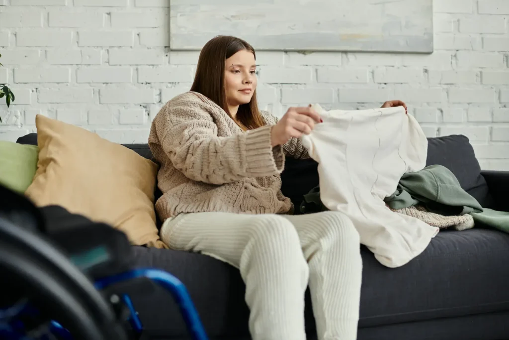 Disabled woman in wheelchair folding laundry