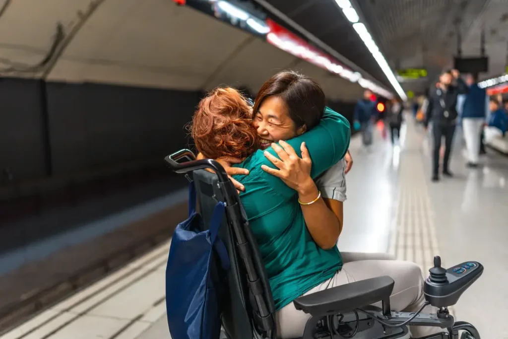Support worker hugging disabled woman