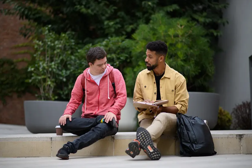Support worker talking with disabled man